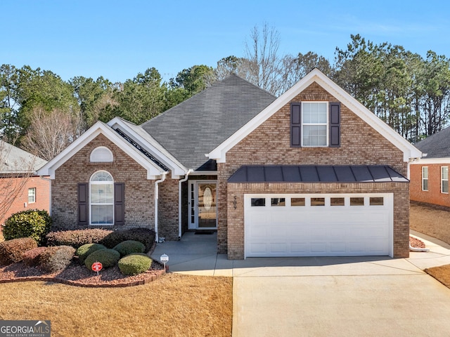 traditional-style house featuring an attached garage, concrete driveway, and brick siding