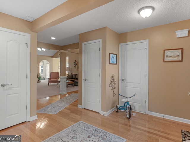 509 Carleton Pl, Locust Grove, GA 30248 - foyer entrance featuring decorative columns, arched walkways, baseboards, and light wood-type flooring