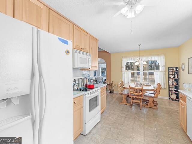 509 Carleton Pl, Locust Grove, GA 30248 - kitchen featuring white appliances, light brown cabinetry, light countertops, a ceiling fan, and arched walkways