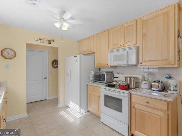 509 Carleton Pl, Locust Grove, GA 30248 - kitchen with white appliances, light brown cabinetry, ceiling fan, light countertops, and a textured ceiling