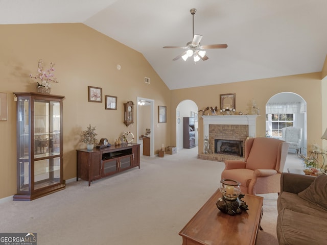 509 Carleton Pl, Locust Grove, GA 30248 - living room featuring arched walkways, ceiling fan, light colored carpet, a brick fireplace, and high vaulted ceiling