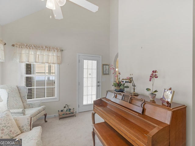 509 Carleton Pl, Locust Grove, GA 30248 - living area with light colored carpet, a ceiling fan, high vaulted ceiling, arched walkways, and baseboards