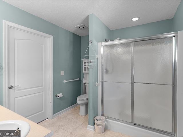 509 Carleton Pl, Locust Grove, GA 30248 - bathroom featuring a stall shower, toilet, a textured ceiling, tile patterned flooring, and vanity
