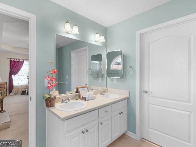 509 Carleton Pl, Locust Grove, GA 30248 - ensuite bathroom featuring double vanity, healthy amount of natural light, and a textured ceiling
