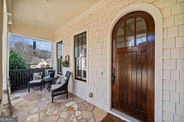 view of exterior entry with covered porch