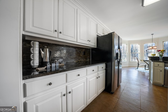 kitchen featuring dark countertops, tasteful backsplash, appliances with stainless steel finishes, and white cabinetry