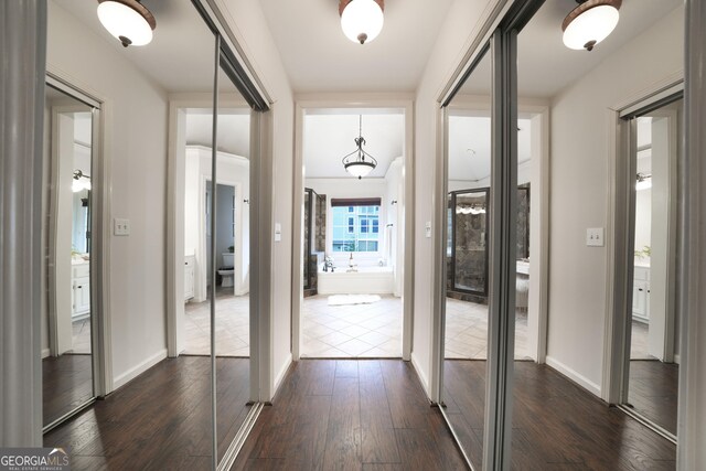 entryway featuring dark wood-type flooring and baseboards