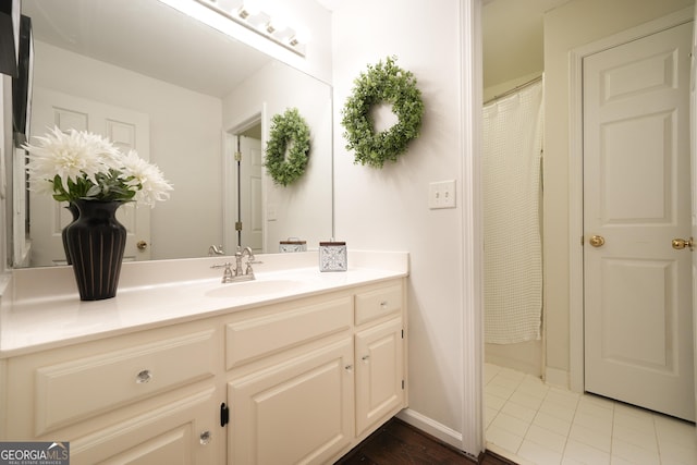 full bathroom featuring tile patterned flooring, vanity, and baseboards