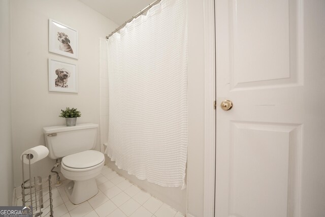 full bath with toilet, tile patterned flooring, and shower / bathtub combination with curtain