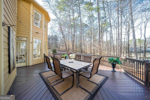 wooden deck featuring outdoor dining area