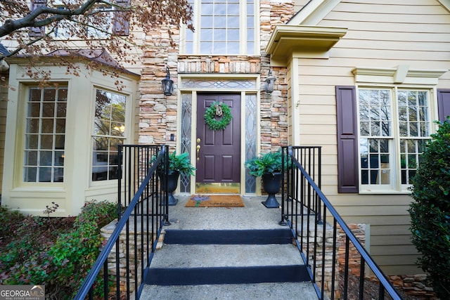 doorway to property featuring stone siding