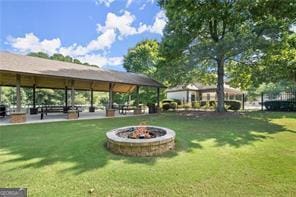 view of property's community with an outdoor fire pit, a lawn, and a gazebo