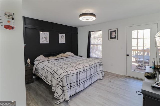 709 Berkeley Woods Unit 709, Duluth, GA 30096 - bedroom with light wood finished floors and access to exterior