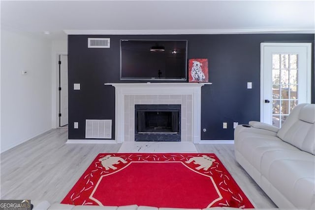 709 Berkeley Woods Unit 709, Duluth, GA 30096 - living area featuring wood finished floors, a fireplace, and ornamental molding