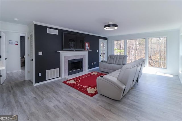 709 Berkeley Woods Unit 709, Duluth, GA 30096 - living area featuring ornamental molding, wood finished floors, and a tile fireplace