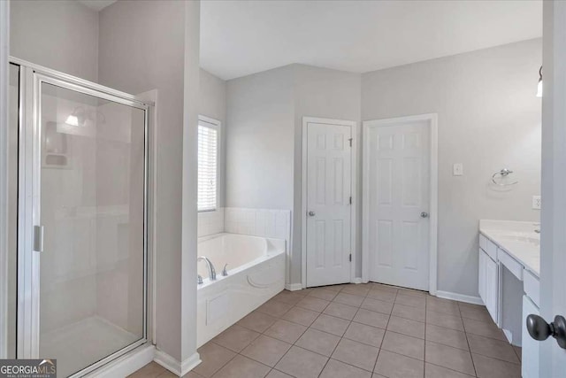 bathroom featuring a stall shower, tile patterned floors, vanity, and a bath