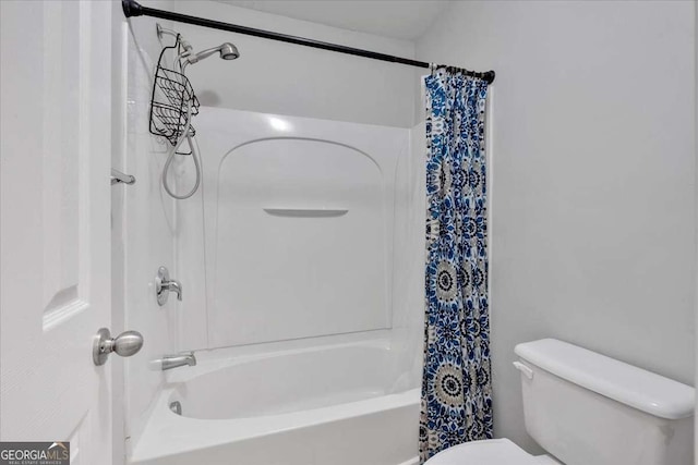 bathroom with toilet and shower / bath combo with shower curtain