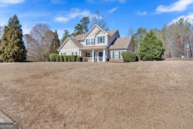 view of front of property with covered porch and a front lawn