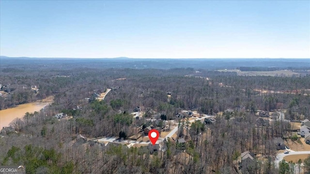 drone / aerial view featuring a water view and a view of trees