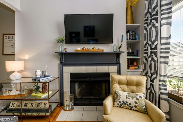 tiled living room featuring a tiled fireplace