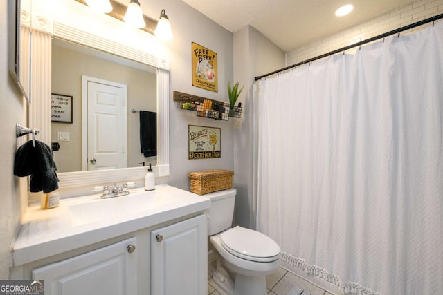 bathroom with vanity, walk in shower, toilet, and tile patterned flooring