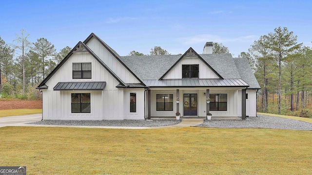 modern farmhouse style home featuring a front yard and a porch