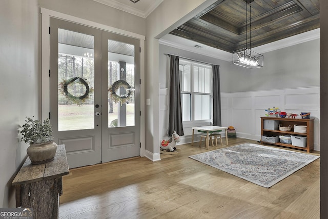 entrance foyer featuring ornamental molding, wood ceiling, wood-type flooring, and french doors