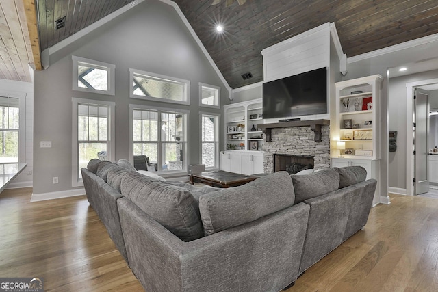 living room with hardwood / wood-style flooring, ornamental molding, a fireplace, and wooden ceiling