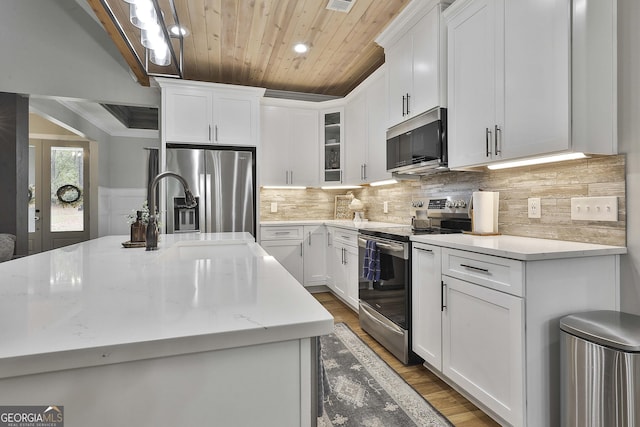 kitchen featuring white cabinetry, appliances with stainless steel finishes, and light stone countertops