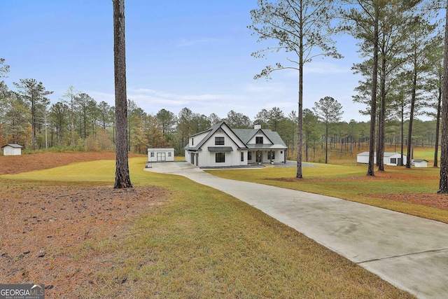 view of front of house with a front lawn and an outdoor structure