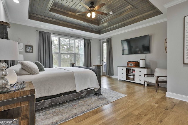 bedroom featuring a tray ceiling, ornamental molding, wooden ceiling, and wood-type flooring