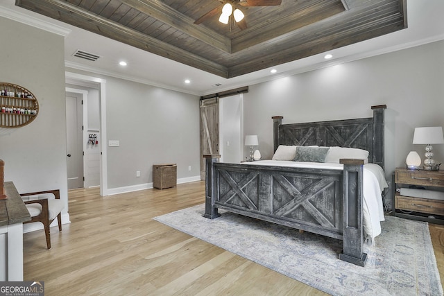 bedroom featuring a barn door, light hardwood / wood-style floors, a raised ceiling, wooden ceiling, and ornamental molding