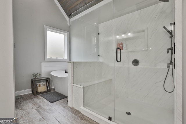 bathroom with hardwood / wood-style floors, vaulted ceiling, independent shower and bath, and ornamental molding