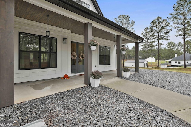 view of exterior entry with a patio