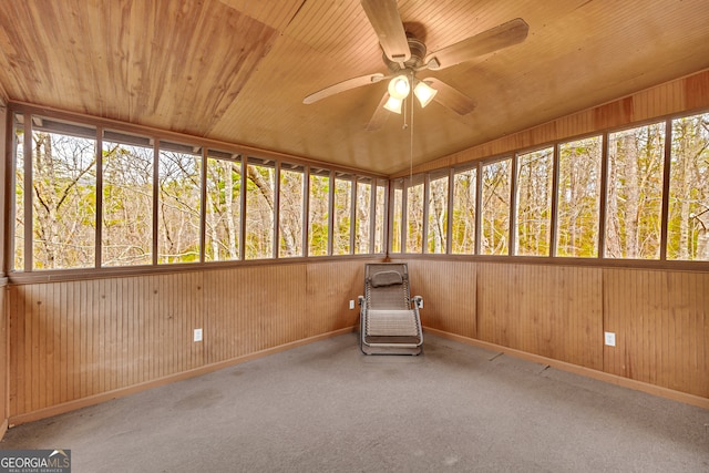 unfurnished sunroom with ceiling fan and wood ceiling