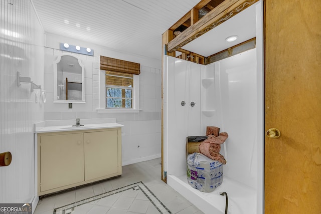 bathroom featuring vanity, tile patterned flooring, and walk in shower