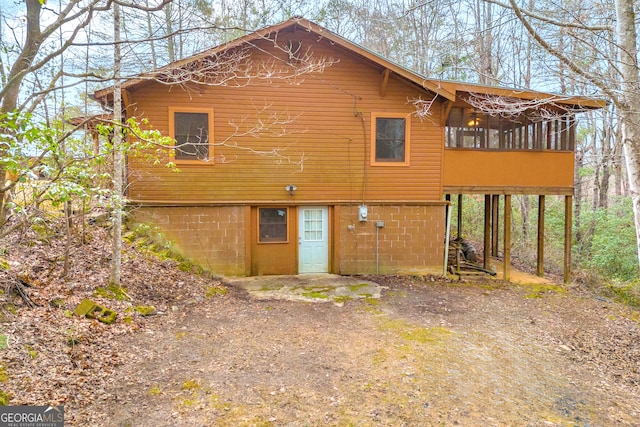 back of house featuring a sunroom