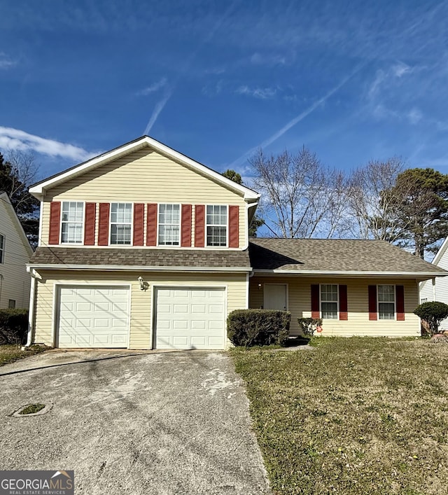 view of front of home with a front yard and a garage