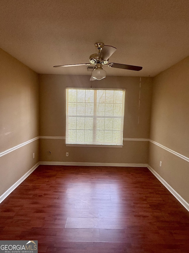 empty room with a textured ceiling, hardwood / wood-style floors, and ceiling fan