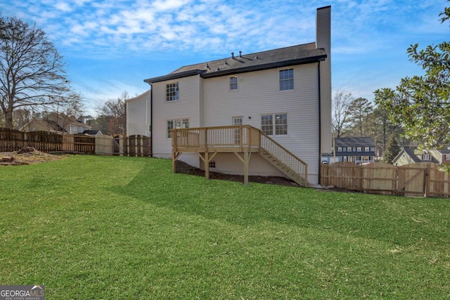 back of house featuring a yard and a wooden deck