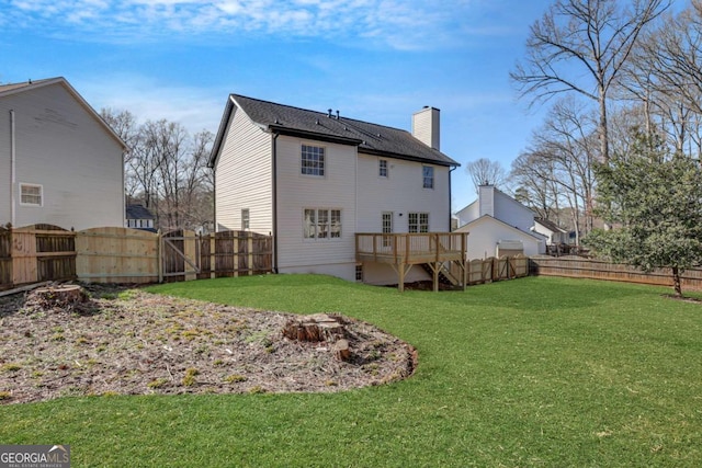 back of house featuring a yard and a deck