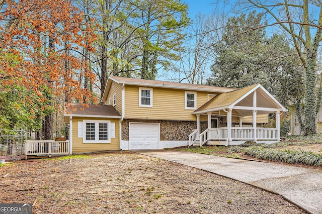 front facade with covered porch and a garage