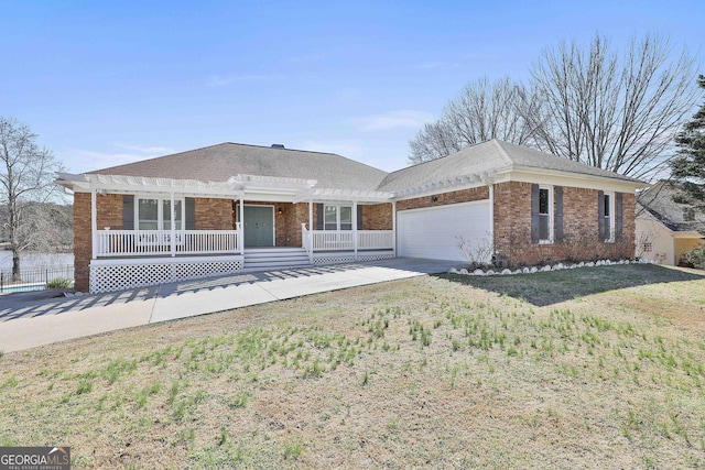 single story home featuring a garage, a front yard, and a porch