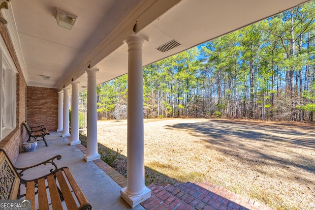 view of patio / terrace with a porch and visible vents