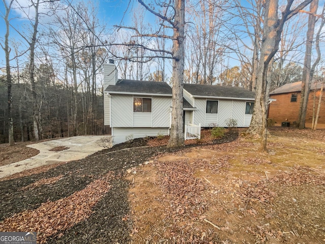 bi-level home featuring a chimney