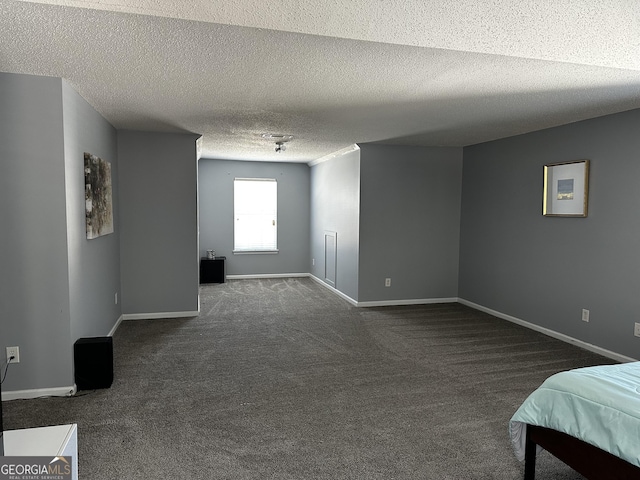 carpeted empty room featuring a textured ceiling