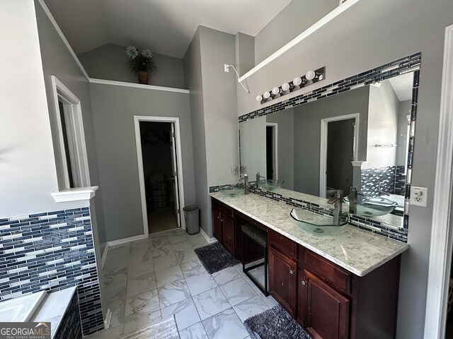bathroom with vanity and lofted ceiling