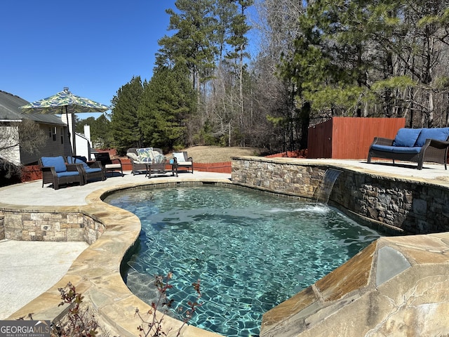 view of pool featuring a patio area, an outdoor living space, and pool water feature