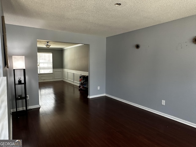 spare room with dark hardwood / wood-style flooring and a textured ceiling