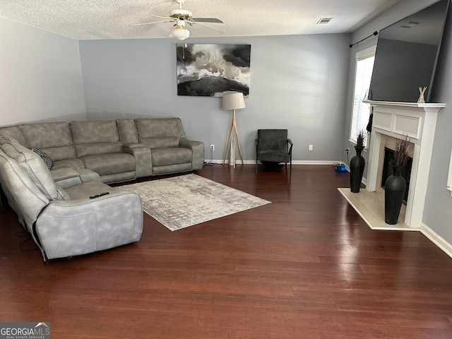 living room featuring a textured ceiling, vaulted ceiling, dark hardwood / wood-style floors, and ceiling fan